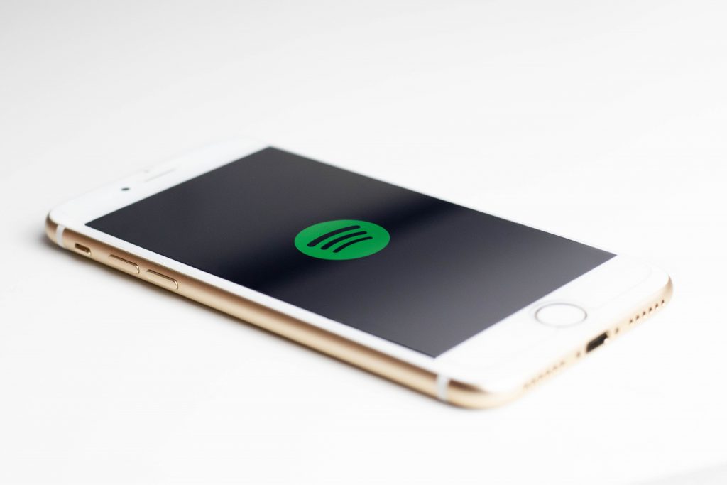 Mobile phone with Spotify logo on the screen.