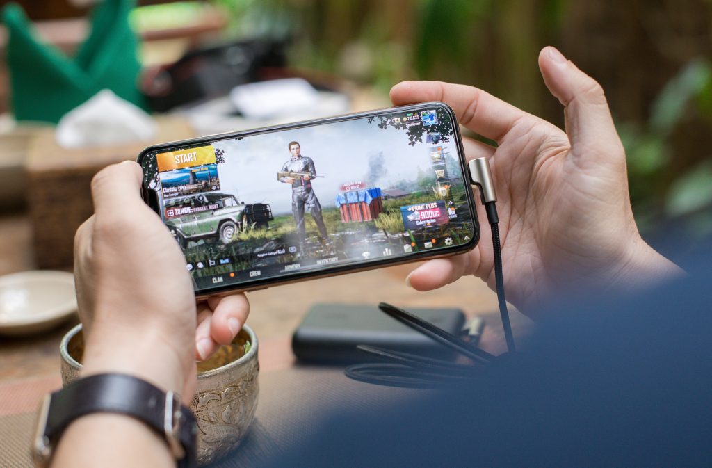 Person playing a game on a mobile phone.